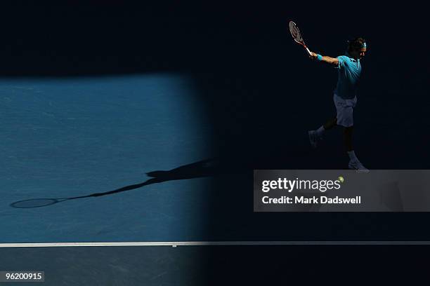 Roger Federer of Switzerland plays a backhand in his quarterfinal match against Nikolay Davydenko of Russia during day ten of the 2010 Australian...