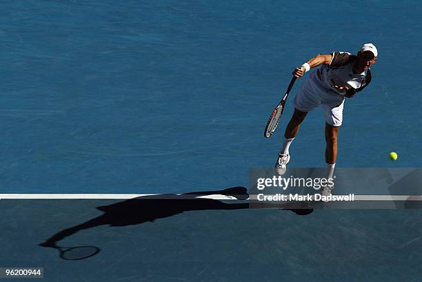 Nikolay Davydenko of Russia serves in his quarterfinal match against Roger Federer of Switzerland during day ten of the 2010 Australian Open at...