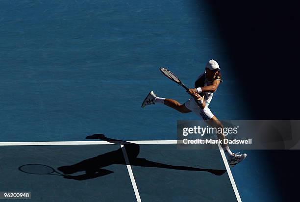 Nikolay Davydenko of Russia plays a backhand in his quarterfinal match against Roger Federer of Switzerland during day ten of the 2010 Australian...