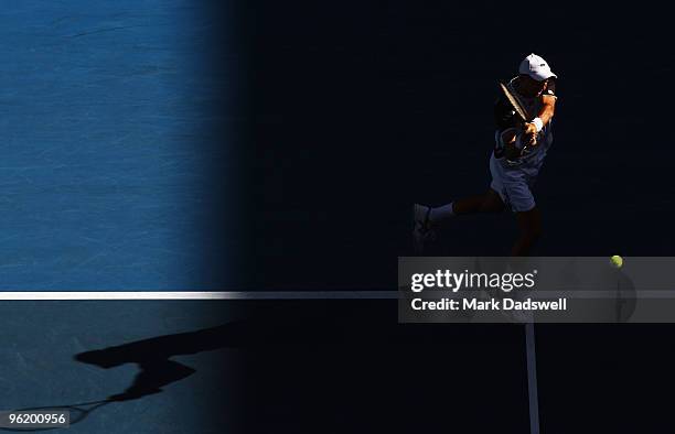 Nikolay Davydenko of Russia plays a backhand in his quarterfinal match against Roger Federer of Switzerland during day ten of the 2010 Australian...