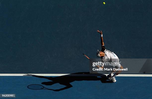 Nikolay Davydenko of Russia serves in his quarterfinal match against Roger Federer of Switzerland during day ten of the 2010 Australian Open at...