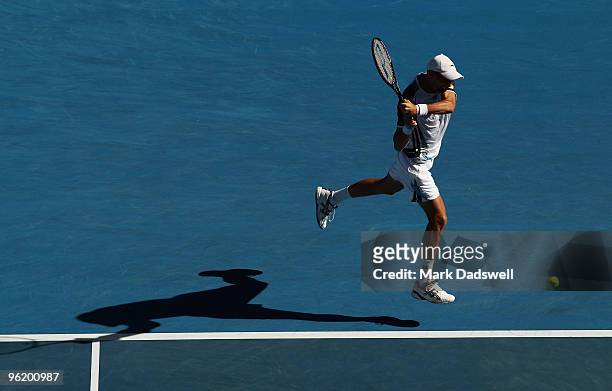 Nikolay Davydenko of Russia plays a backhand in his quarterfinal match against Roger Federer of Switzerland during day ten of the 2010 Australian...
