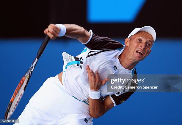 Nikolay Davydenko of Russia serves in his quarterfinal match against Roger Federer of Switzerland during day ten of the 2010 Australian Open at...