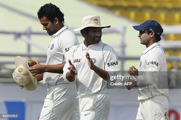 Indian cricketer Sachin Tendulkar , teammates Zaheer Khan and Amit Mishra leave the field after defeating Bangladesh during the fourth day of the...