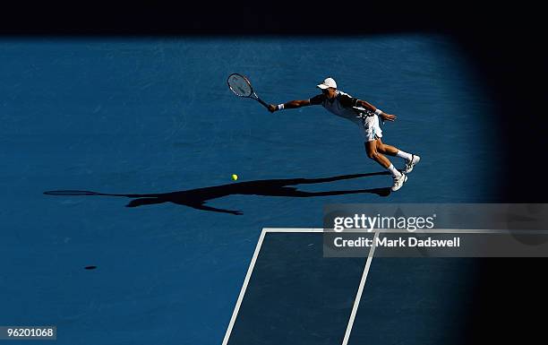 Nikolay Davydenko of Russia plays a forehand in his quarterfinal match against Roger Federer of Switzerland during day ten of the 2010 Australian...