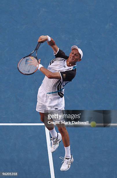 Nikolay Davydenko of Russia plays a forehand smash in his quarterfinal match against Roger Federer of Switzerland during day ten of the 2010...
