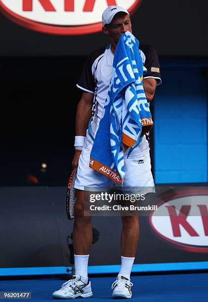 Nikolay Davydenko of Russia towels down in his quarterfinal match against Roger Federer of Switzerland during day ten of the 2010 Australian Open at...