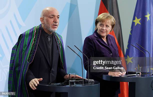 German Chancellor Angela Merkel and Afghan President Hamid Karzai speak to the media after talks at the Chancellery on January 27, 2010 in Berlin,...