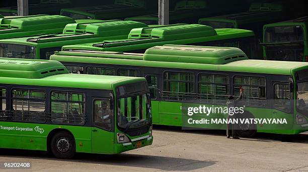 Low-floor CNG buses of the Delhi Transport Corporation are seen parked at a bus depot in New Delhi on January 27, 2010. AFP PHOTO/ MANAN VATSYAYANA