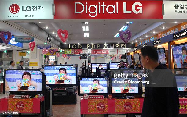 Customer walks past LG Electronics Inc. Liquid-crystal display television sets at an electronics shop in Seoul, South Korea, on Wednesday, Jan. 27,...