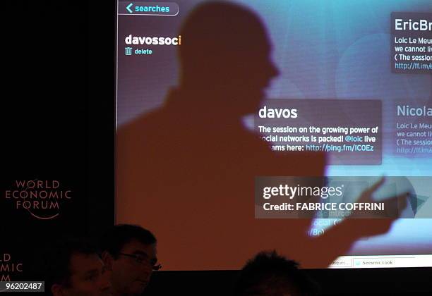The shadow of a participants is seen on a screen showing on Davos' Twitter during a session untitled "The Growing Influence of Social Networks" on...