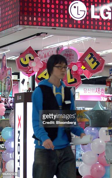 Man waks past an LG Electronics Inc.'s shop in Seoul, South Korea, on Wednesday, Jan. 27, 2010. LG Electronics Inc., the world's second-largest maker...