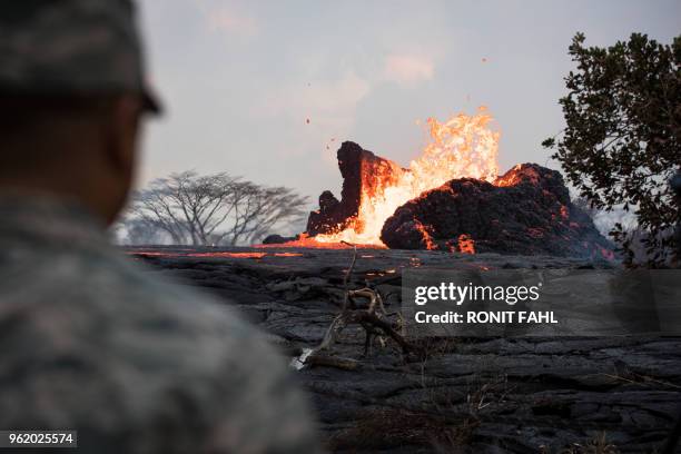 The National Guard watches as a lava lake forms in the Leilani Estates subdivision, situated on Kilauea's East Rift Zone, on May 23, 2018 in Pahoa,...