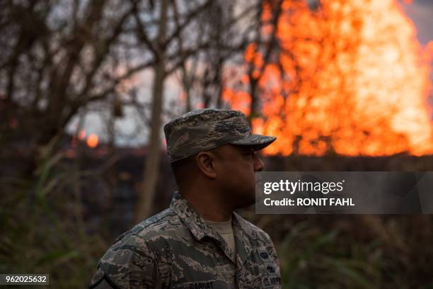 The National Guard watches as a lava lake forms in the Leilani Estates subdivision, situated on Kilauea's East Rift Zone, on May 23, 2018 in Pahoa,...