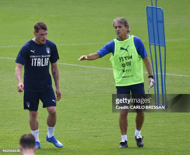 Italy's national football team new coach Roberto Mancini speaks with Italy's striker Andrea Belotti during a training session on May 24, 2018 at...