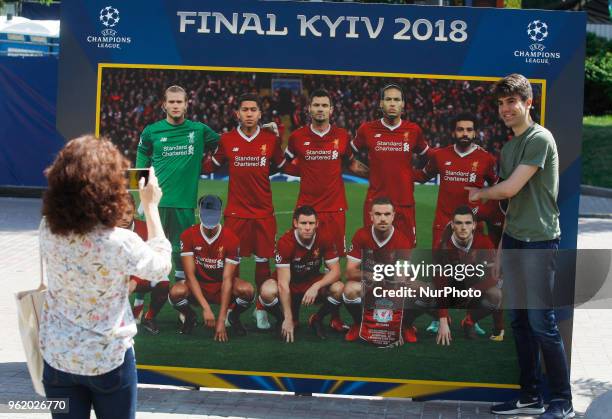 Visitors take a photo during the opening ceremony of the Champions Festival in the UEFA Champions League Final fan zone in Kyiv, Ukraine, 24 May,...