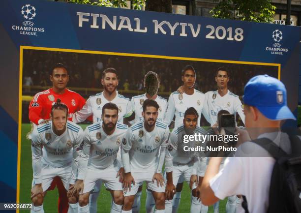Visitors take a photo during the opening ceremony of the Champions Festival in the UEFA Champions League Final fan zone in Kyiv, Ukraine, 24 May,...
