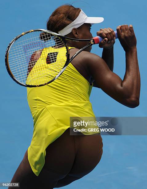 Venus Williams of the US hits a return against Li Na of China in their women's singles quarter-final match on day 10 of the Australian Open tennis...