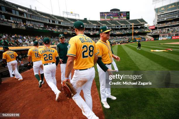 Third Base Coach Matt Williams of the Oakland Athletics congratulates members of the Athletics on the field following the game against the Baltimore...