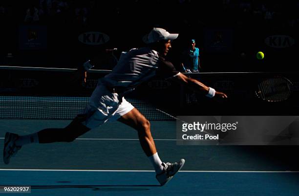 Nikolay Davydenko of Russia plays a forehand in his quarterfinal match against Roger Federer of Switzerland during day ten of the 2010 Australian...