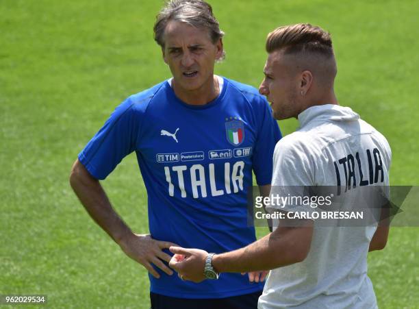 Italy's national football team new coach Roberto Mancini speaks with Italy's striker Ciro Immobile during a training session on May 24, 2018 at...