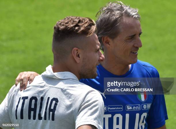 Italy's national football team new coach Roberto Mancini speaks with Italy's striker Ciro Immobile during a training session on May 24, 2018 at...