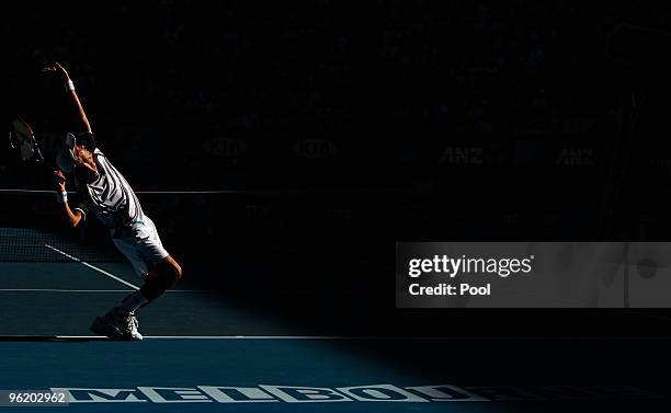 Nikolay Davydenko of Russia serves in his quarterfinal match against Roger Federer of Switzerland during day ten of the 2010 Australian Open at...