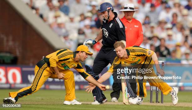 Australia's captain Ricky Ponting and bowler Steve Smith both try to field the ball in front of non-striking batsman Andrew Strauss of England during...