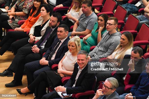 Sinn Fein politician Michelle O'Neill listens to Labour leader Jeremy Corbyn, delivering a speech at Queens University on May 24, 2018 in Belfast,...