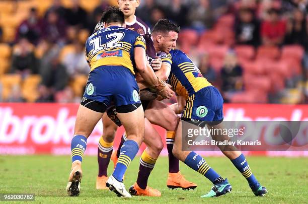Darius Boyd of the Broncos is tackled during the round 12 NRL match between the Brisbane Broncos and the Parramatta Eels at Suncorp Stadium on May...