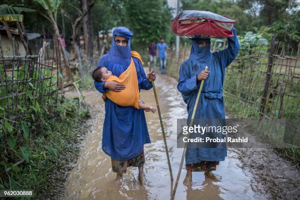 Dil Newaz holding her one year old child and Nazma Begum from Myanmar who have crossed the border into Bangladesh on 2 September 2017, after three...