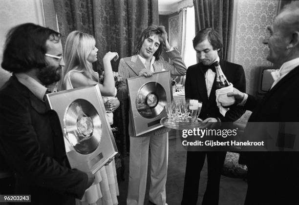 24th FEBRUARY: British musician Rod Stewart with his partner Britt Ekland pose with gold discs at a press conference to promote his LP 'Atlantic...