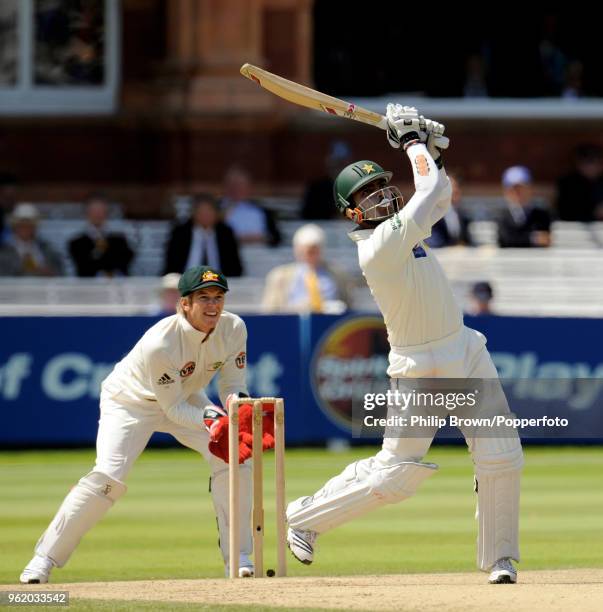 Umar Akmal of Pakistan hits a six watched by Tim Paine of Australia during the 1st Test match between Australia and Pakistan at Lord's Cricket...