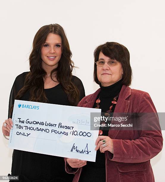 Model Danielle Lloyd presents a cheque to Judy Morgan from "Guiding Light/The Lantern Project', on January 27, 2010 in London, England. Lloyd won the...