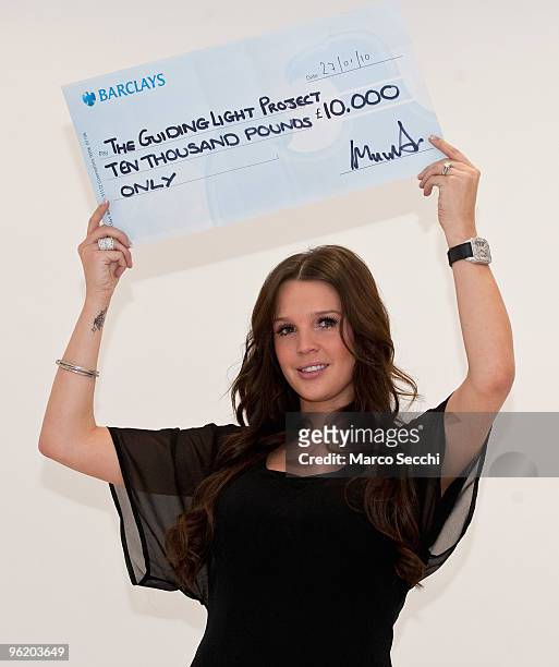 Model Danielle Lloyd poses with a cheque to be presented to Judy Morgan from "Guiding Light/The Lantern Project', on January 27, 2010 in London,...