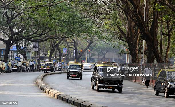 Compressed Natural Gas taxis are driven down a road in Mumbai on January 27, 2009. AFP PHOTO/ Sajjad HUSSAIN