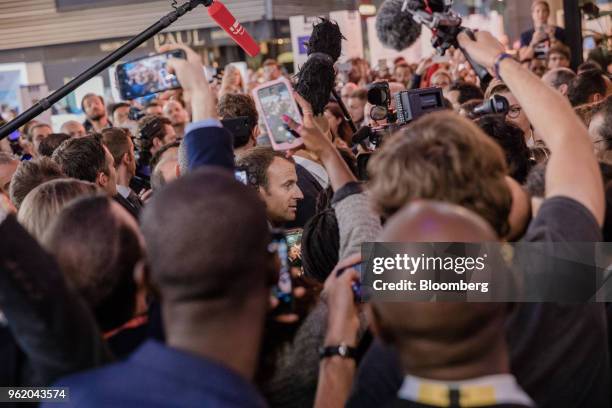 Emmanuel Macron, Frances president, center, is surrounded by members of the media as he arrives at the Viva Technology conference in Paris, France,...