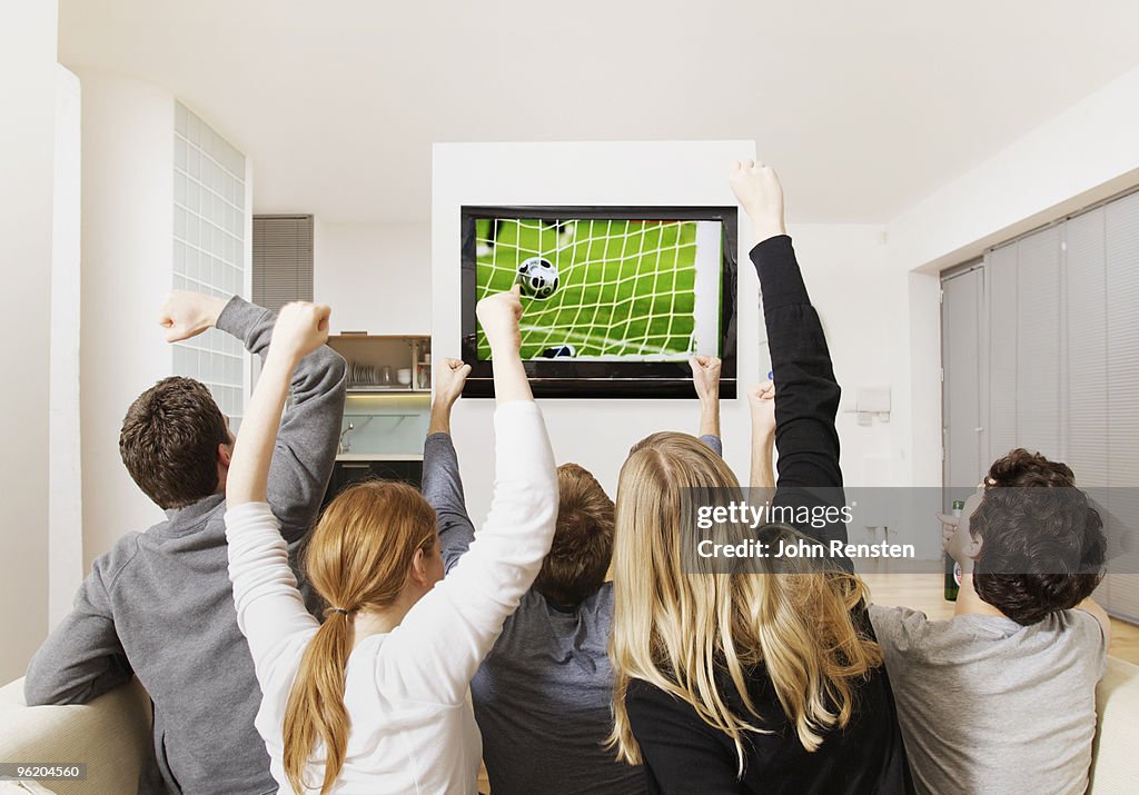 Fans cheering world cup football on television