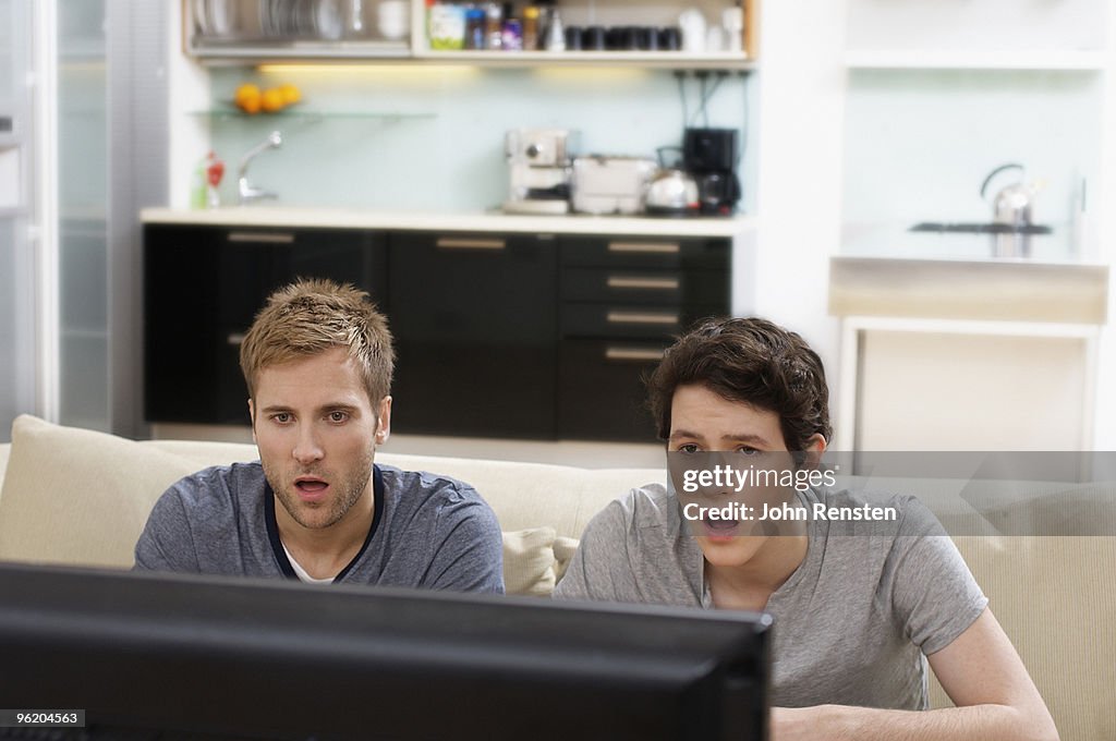 Stunned fans open mouthed watching sport on tv