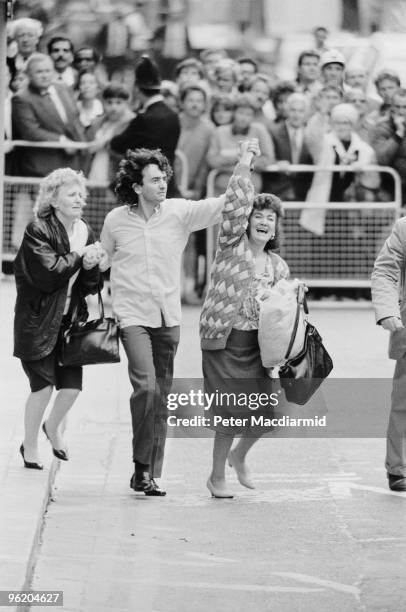 Gerry Conlon, one of the 'Guildford Four' leaves the Old Bailey, London, with his sisters, after the sentences in the case were quashed, 19th October...