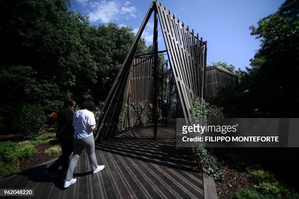 People visit a chapel by Norman Foster part of the Holy See pavilion at the 16th International Architecture Exhibition in Venice, on May 24, 2018....