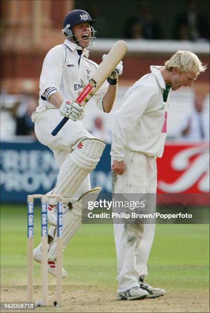 Phil Weston of Gloucestershire celebrates reaching his century during his innings of 110 not out as Worcestershire bowler Gareth Batty shouts in...