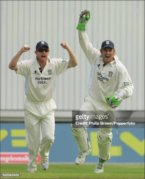 Paul Collingwood and wicketkeeper Phil Mustard of Durham celebrate a Lancashire wicket during the LV County Championship match between Lancashire and...