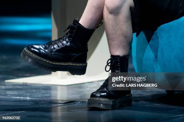 Former US soldier Chelsea Manning's boots are seen as she speaks during the C2 conference in Montreal, Quebec, on May 24, 2018.