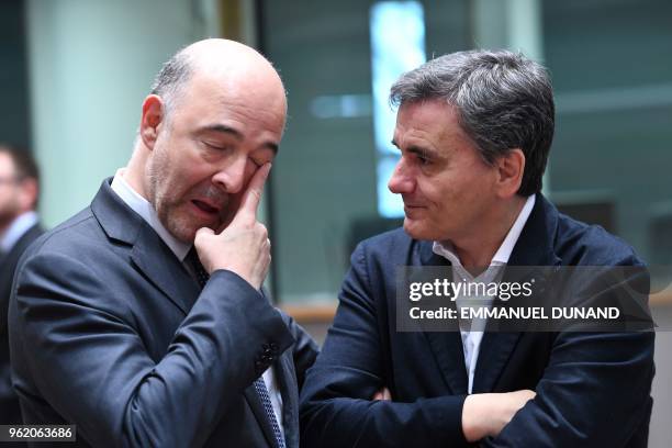 European Commissioner for Economic and Financial Affairs, Taxation and Customs Pierre Moscovici and Greece's Finance Minister Euclid Tsakalotos...