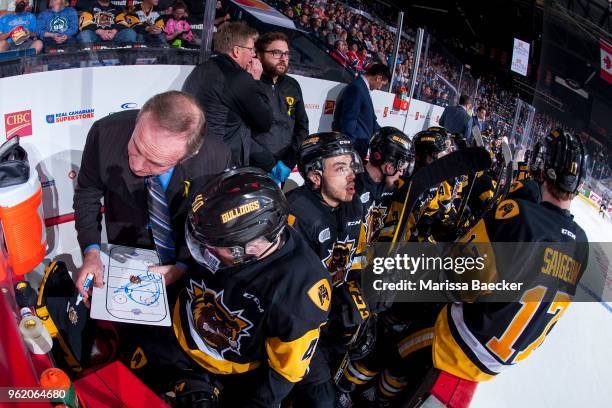 Hamilton Bulldogs' coach Ron Wilson goes over a play on the bench with Ryan Moore of Hamilton Bulldogs against the Acadie-Bathurst Titan at Brandt...