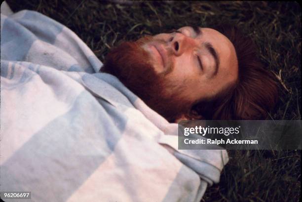 Close-up of a beared festival goer as he catches up on his sleep during the Woodstock Music and Arts Fair, Bethel, New York, August 1969. The...