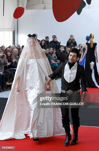 French designer Alexis Mabille walks with a model during the presentation of his the spring-summer 2010 haute couture collection show on January 25,...