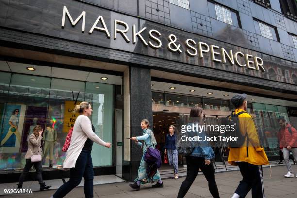 Shoppers walk past a Marks and Spencer store on Oxford Street on May 24, 2018 in London, England. M&S has suffered a sharp fall in profits following...