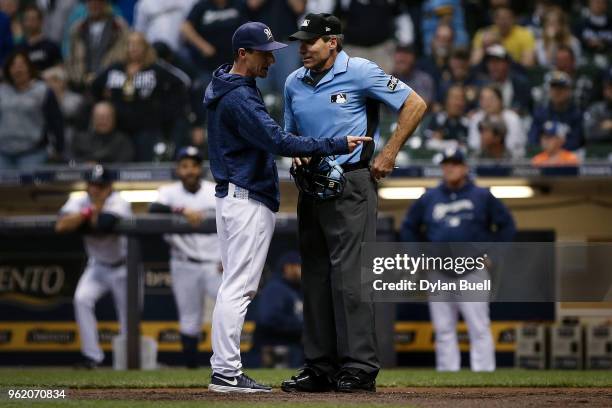 Manager Craig Counsell of the Milwaukee Brewers argues with umpire Angel Hernandez in the ninth inning against the Arizona Diamondbacks at Miller...